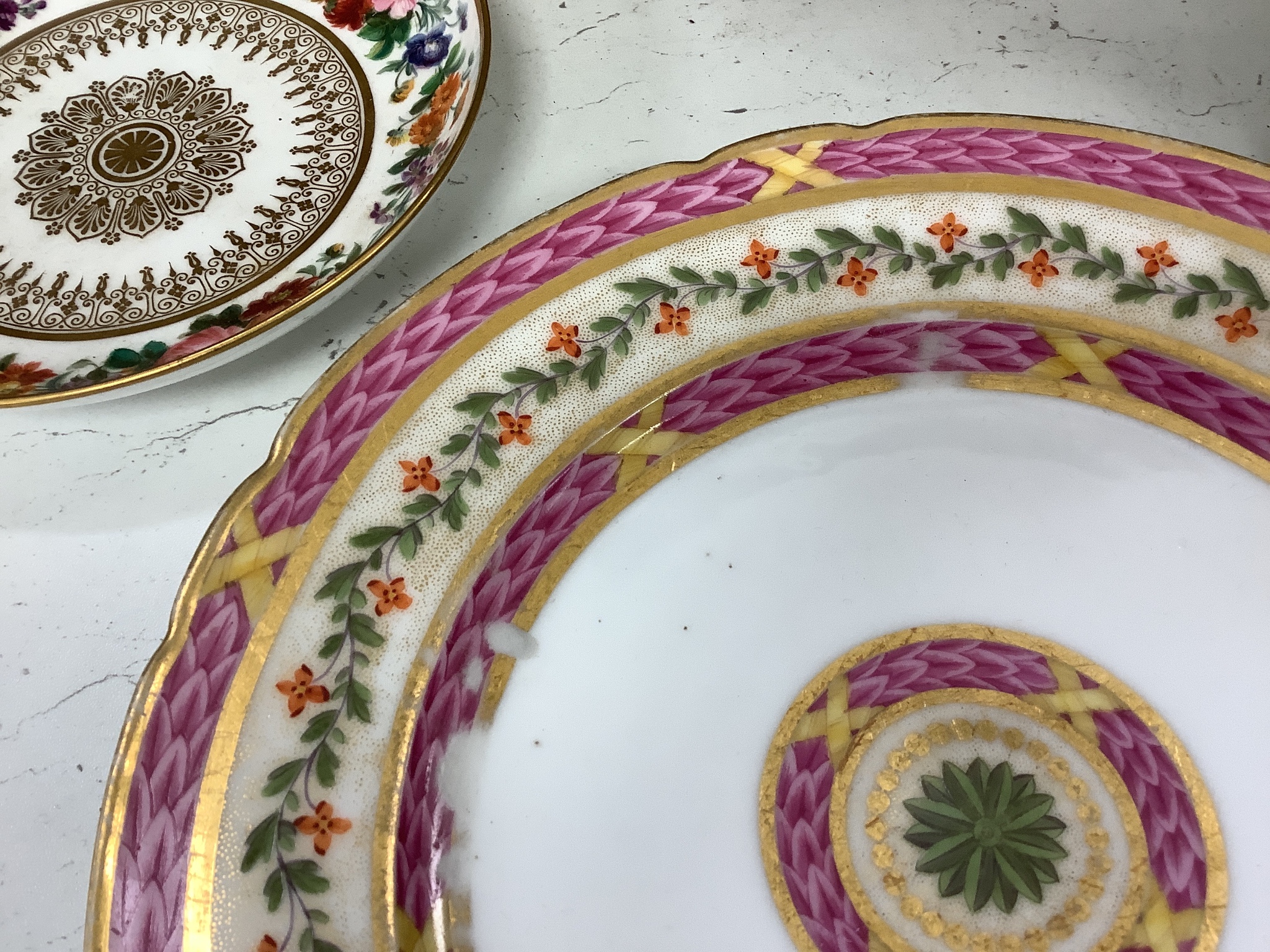 A Sevres circular dish finely painted with flowers and intricately gilded, blue mark, 1850's and a Rue Thiroux or Fabrique de la reine porcelain plate with Queen Marie Antoinette' mark of Crown over A stencilled in red,